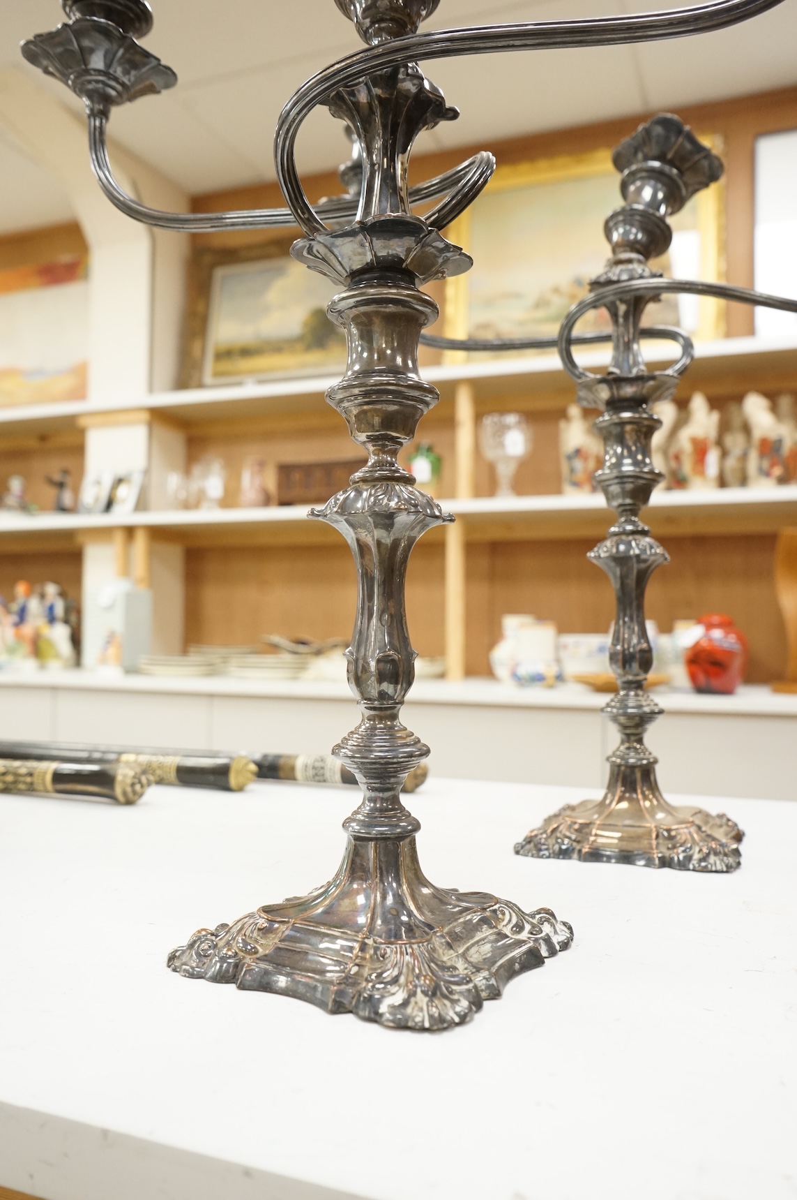 A pair of silver plated two branch three light candelabra, 53cm high